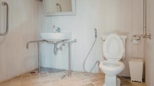 Accessible bathroom fitted with a basin, toilet and wall mounted grab rails