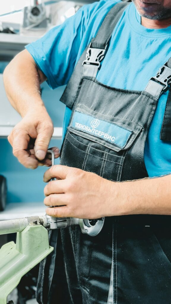 Professional plumber repairing a pipe with a wrench